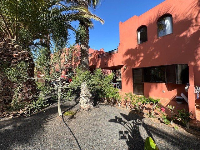 The terracotta block and the path to the apartment