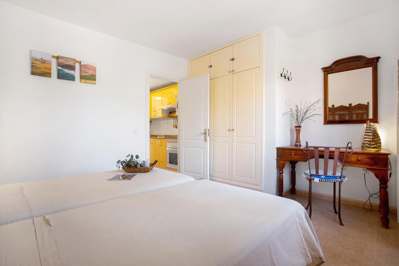 Bedroom with bed, desk and mirror