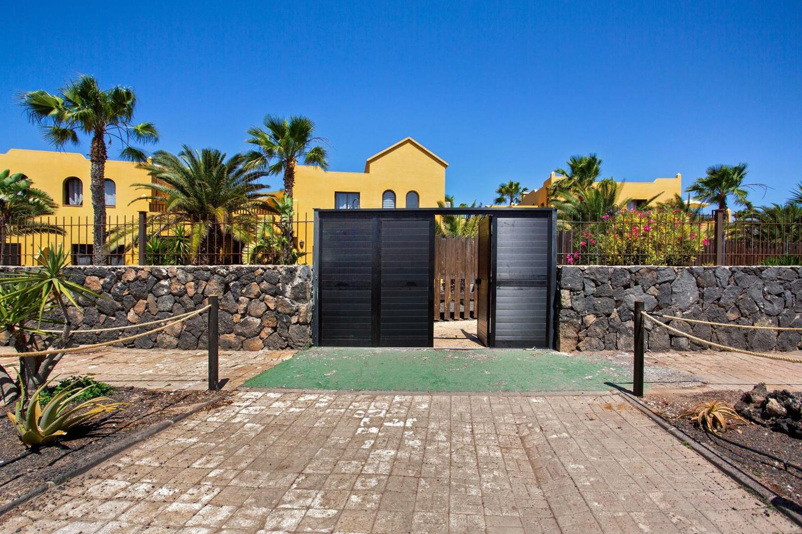 Private entrance gate and stone wall
