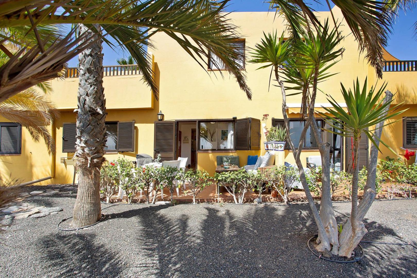 The apartment building with palms in front