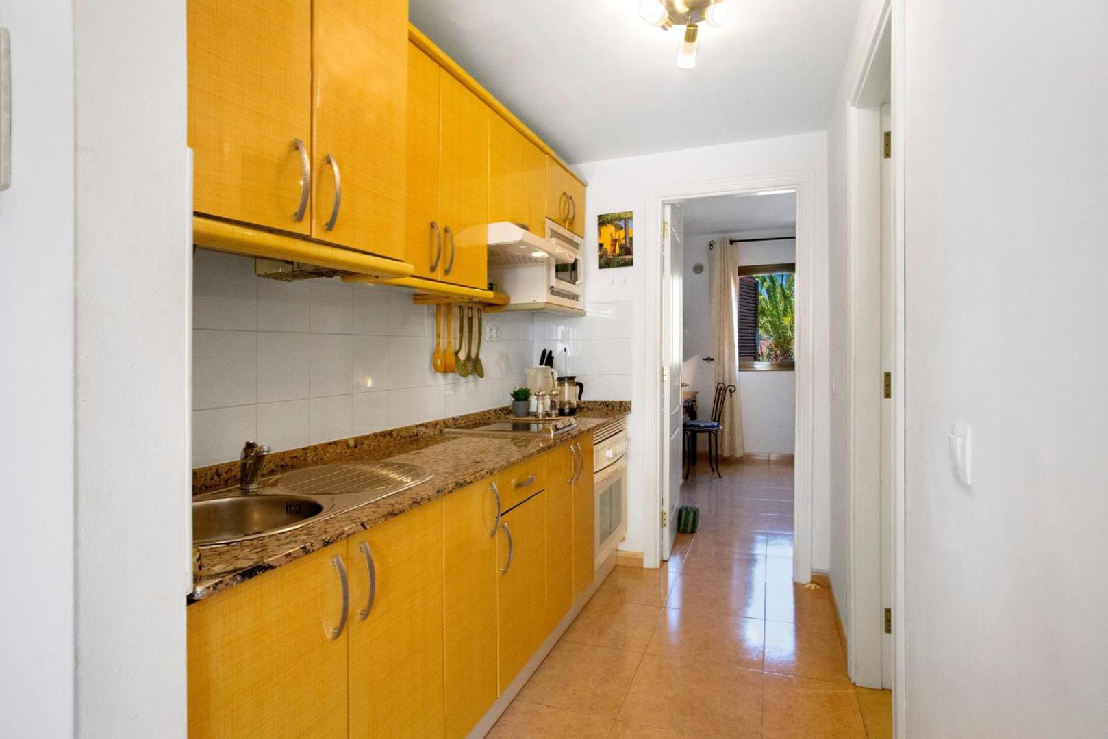 Compact kitchen with wooden cabinets and a sink