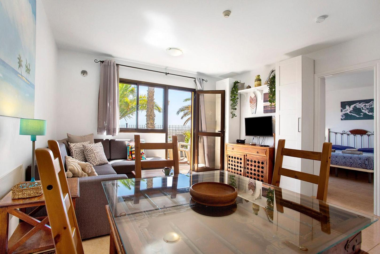 Living room with a glass table and sofa