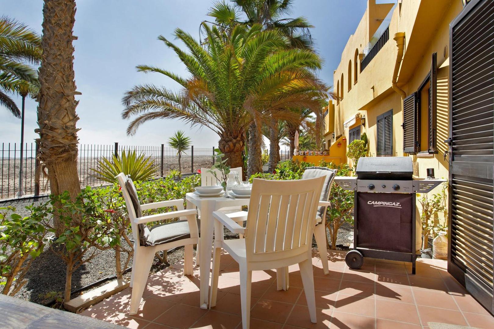 Terrace with table, chairs and barbecue